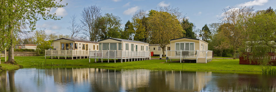 holiday home static caravans at the edge of a river